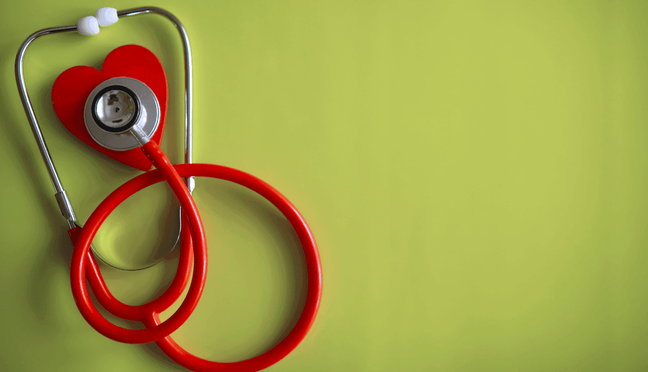 rotes Stethoskop auf grünem Hintergrund 